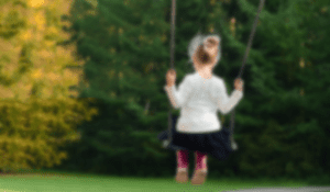 little blonde girl on swingset