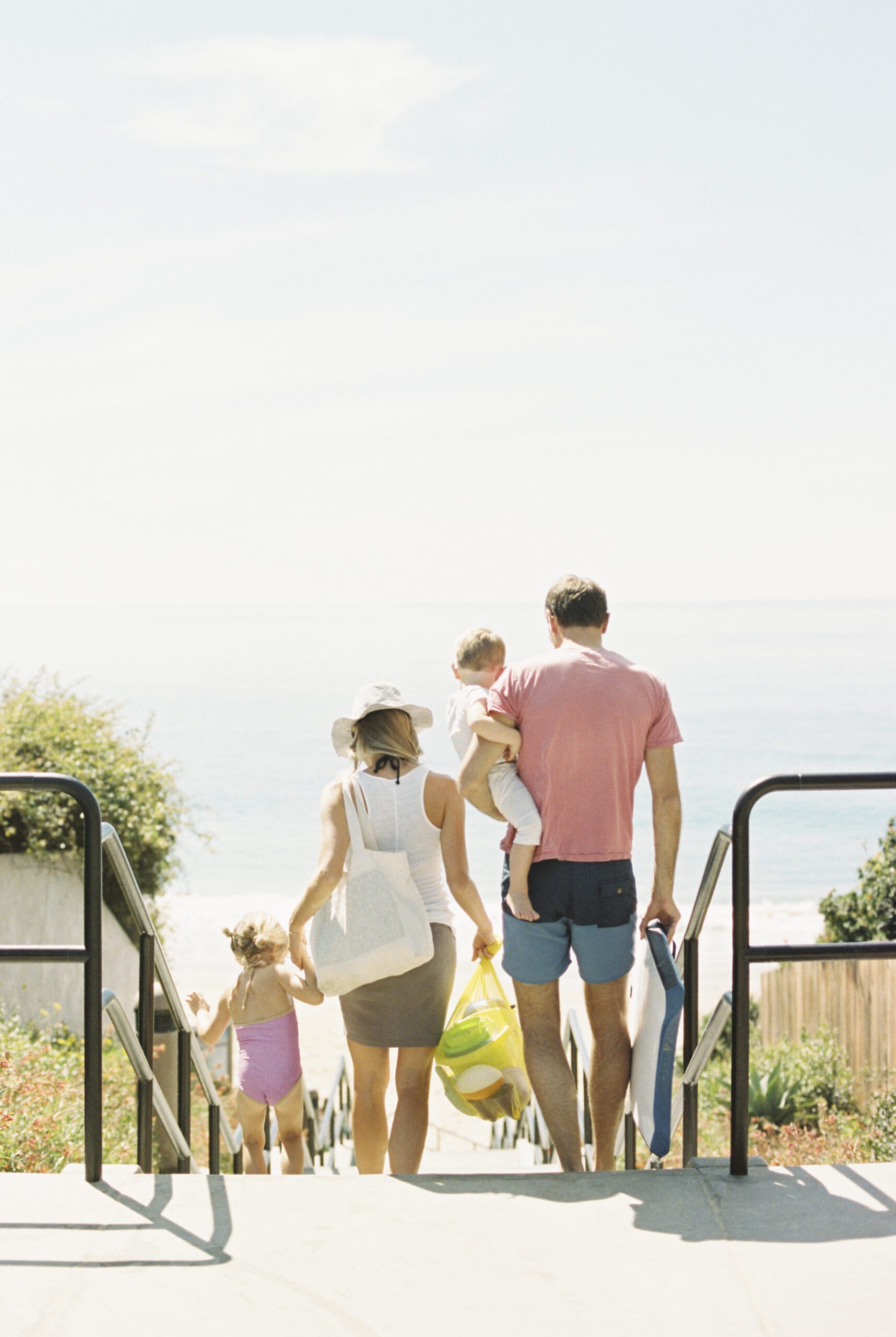 family walking down steps at the beach