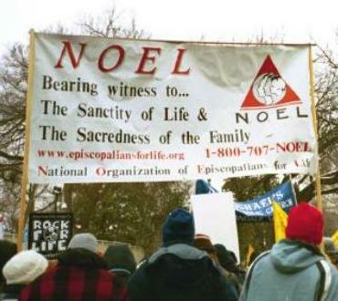 NOEL supporters holding a sign at the March for Life