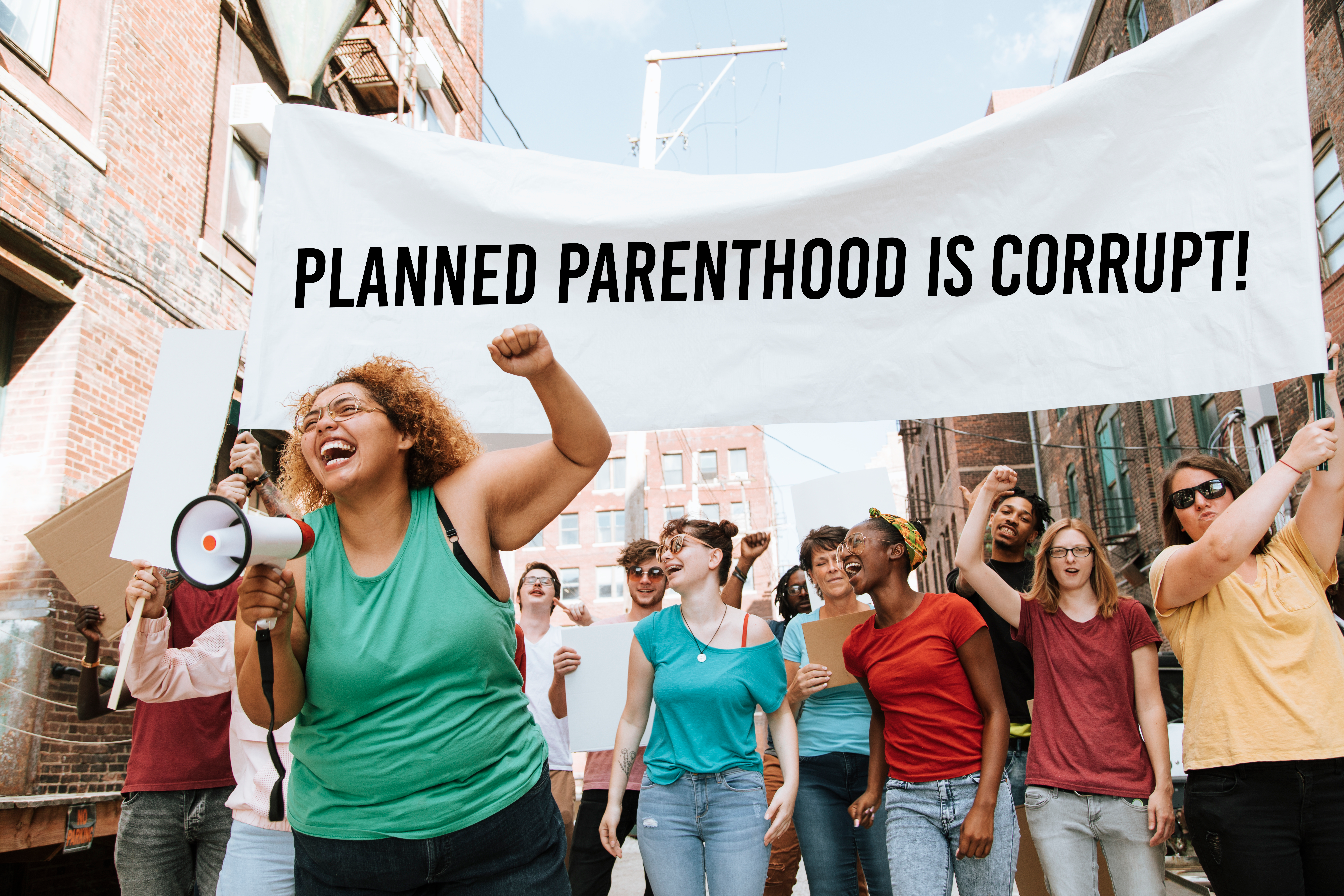 Group of women marching with "Planned Parenthood is Corrupt" sign