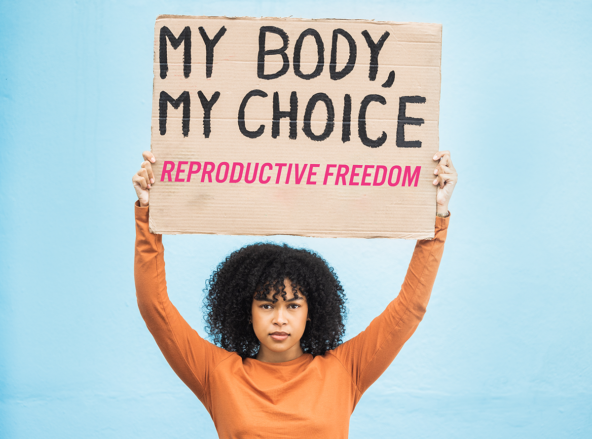 woman holding my body my choice reproductive freedom sign