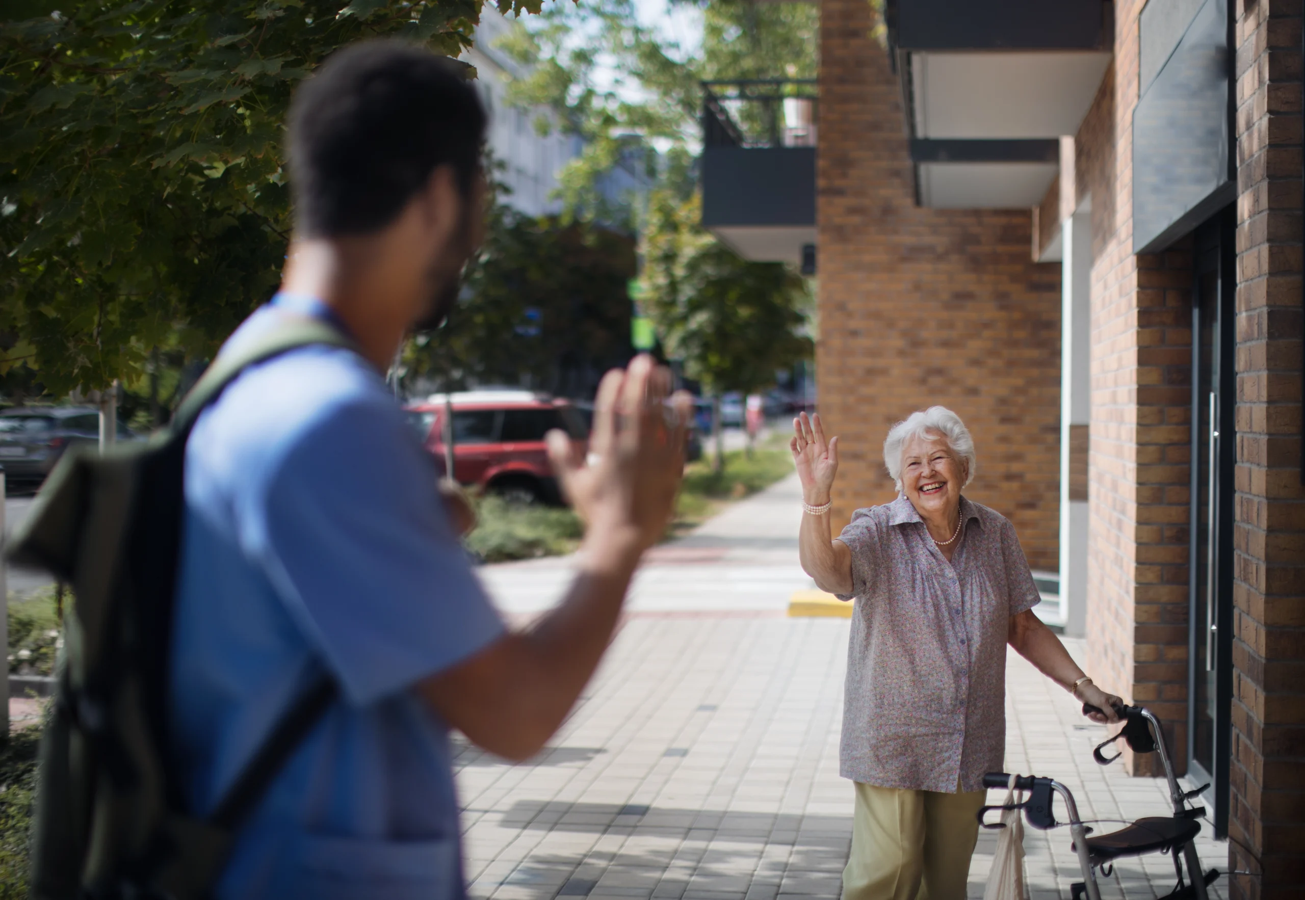 caregiver-saying-goodbye-his-senior-woman-client-a-2026-01-05-22-50-02-utc caregiver waving to senior woman