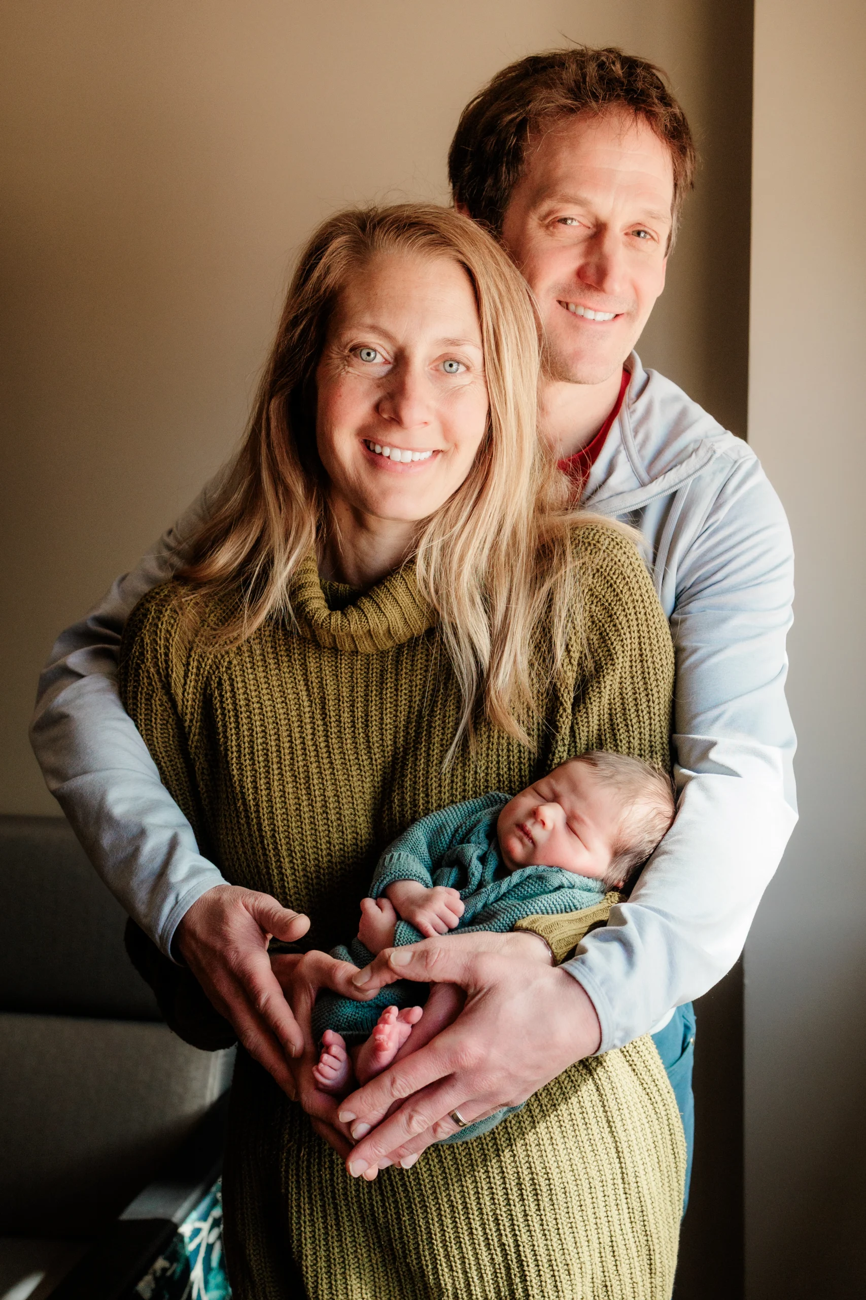 parents holding baby