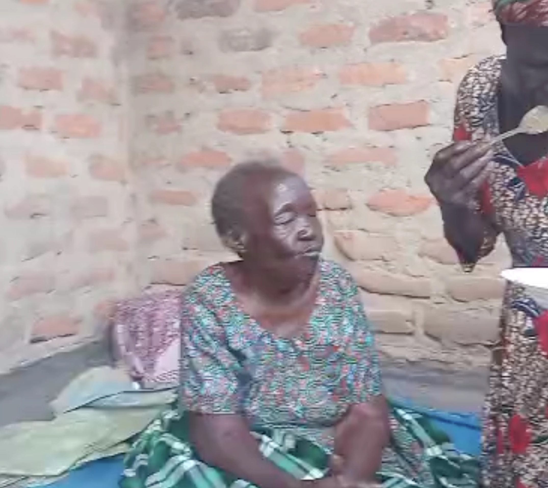 Elderly woman sitting outside